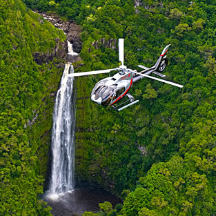 Helicopter flying over Hawaii waterfall